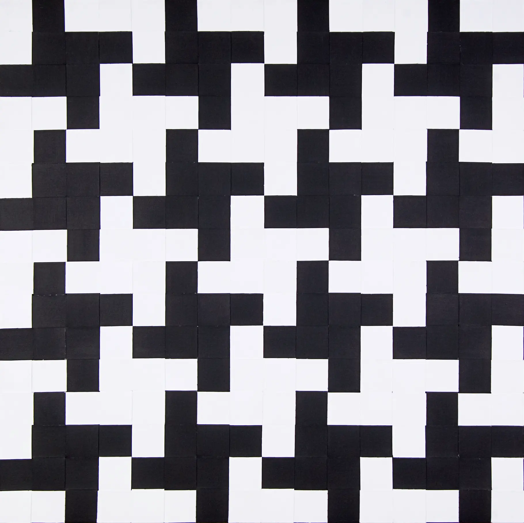 A black and white geometric pattern featuring interlocking L-shaped blocks.