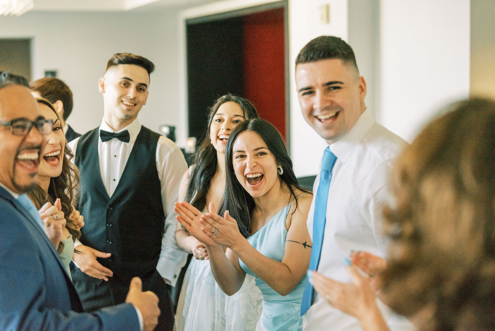 Wedding guests clapping and cheering during a speech